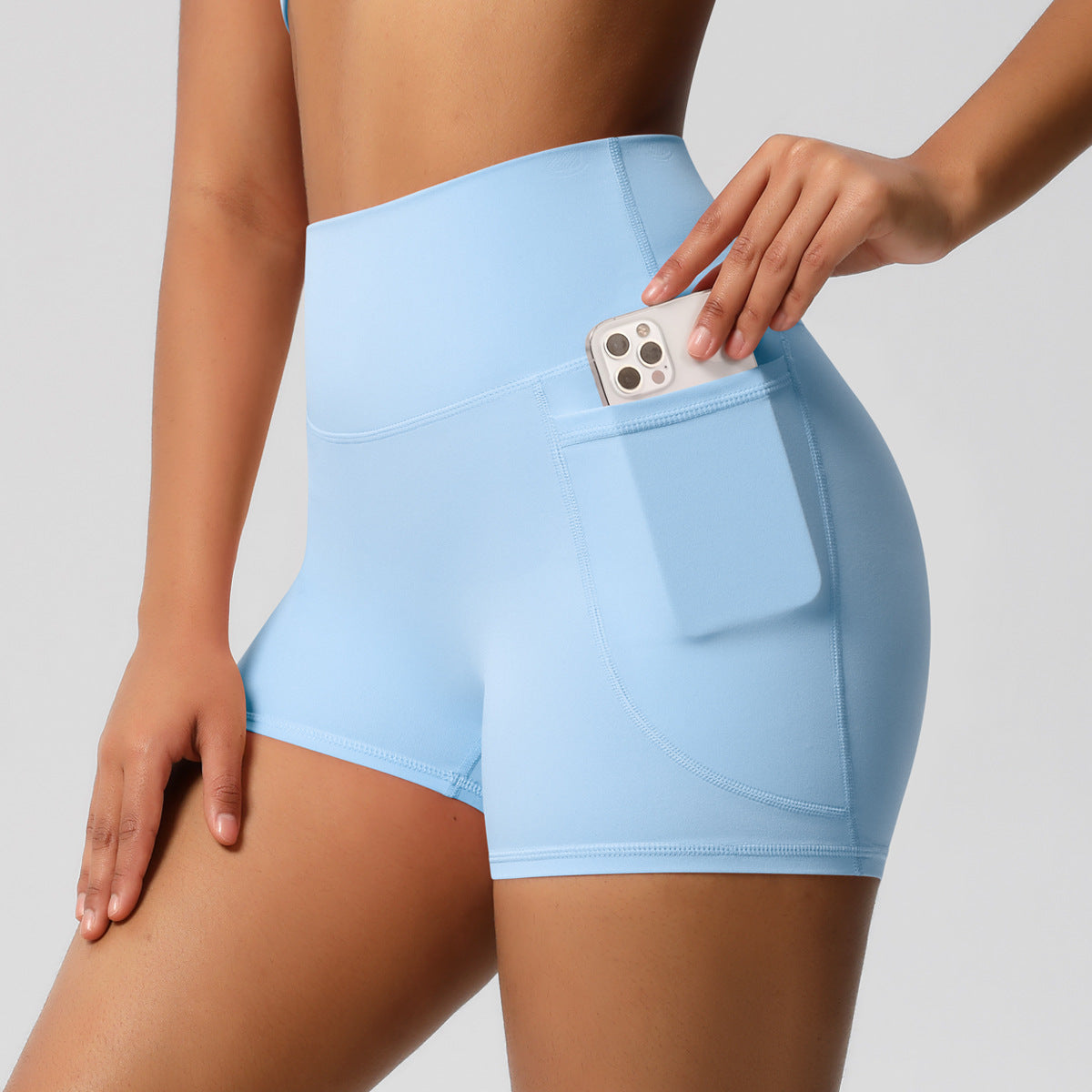 Shorts de ioga femininos com bolsos, modelo três-quartos, cor pêssego.