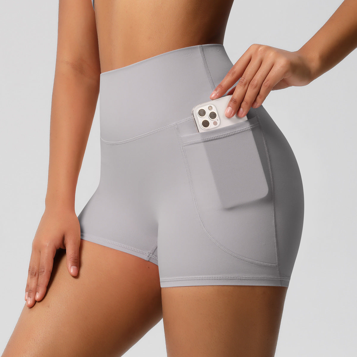 Shorts de ioga femininos com bolsos, modelo três-quartos, cor pêssego.