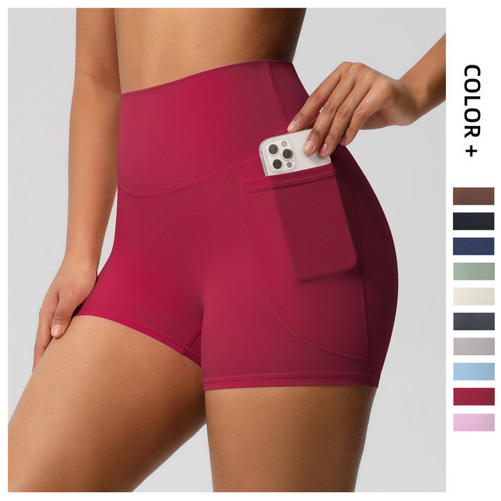 Shorts de ioga femininos com bolsos, modelo três-quartos, cor pêssego.